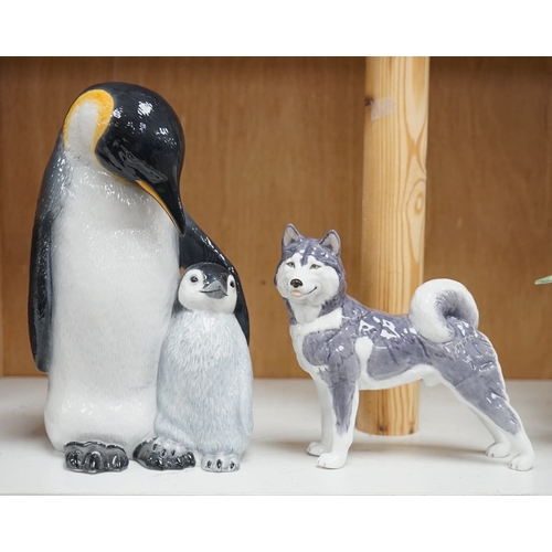 1365 - A Royal Copenhagen penguin group and a similar husky figure, 088 and 038, tallest 22cm. Condition - ... 