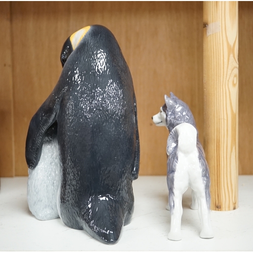 1365 - A Royal Copenhagen penguin group and a similar husky figure, 088 and 038, tallest 22cm. Condition - ... 