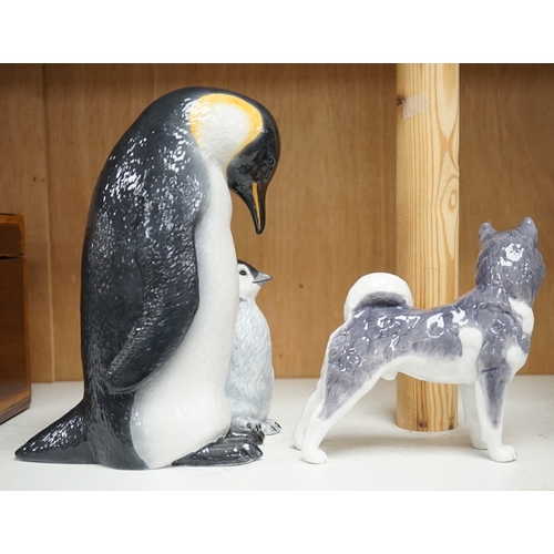 1365 - A Royal Copenhagen penguin group and a similar husky figure, 088 and 038, tallest 22cm. Condition - ... 