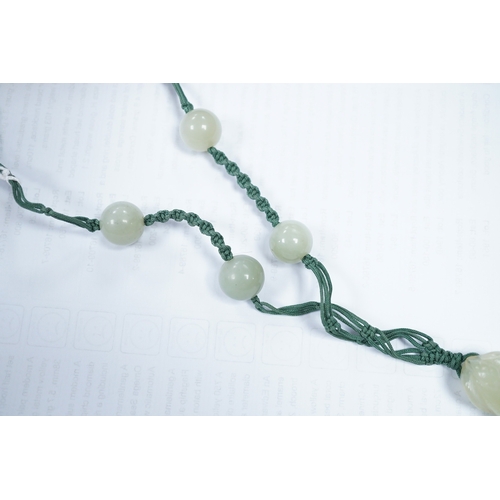 1416 - A Chinese bowenite jade pendant and bead necklace. Condition - fair to good