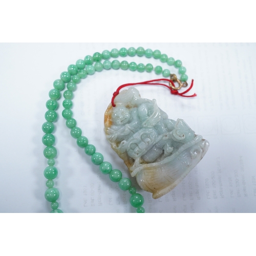 1427 - A Chinese jadeite carving and jadeite bead necklace, carving 6.5cm long. Condition - good