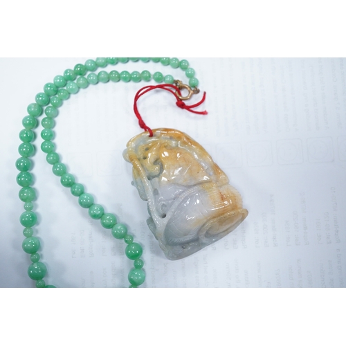 1427 - A Chinese jadeite carving and jadeite bead necklace, carving 6.5cm long. Condition - good