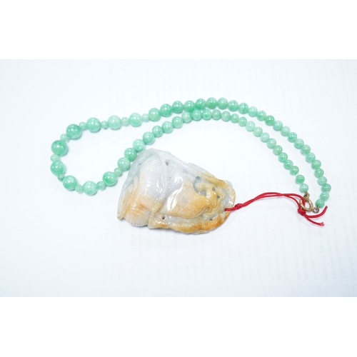 1427 - A Chinese jadeite carving and jadeite bead necklace, carving 6.5cm long. Condition - good