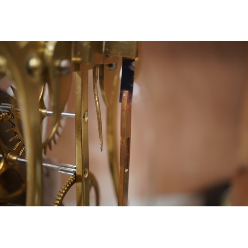 1457 - A late 19th century brass skeleton timepiece, the silvered chapter ring with Roman numerals, on a st... 