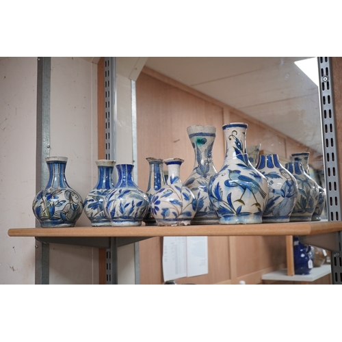 1469 - A large collection of Persian, predominantly blue and white, guglets, 18th century, largest 21.5cm. ... 