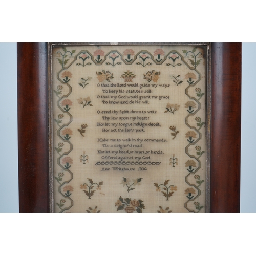 1503 - A wide mahogany framed sampler by Ann Whitehouse dated 1834, worked in coloured silks on a fine line... 