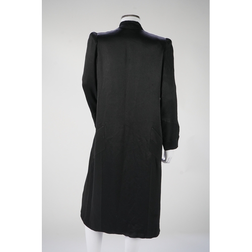 1512 - A 1930's black satin evening coat, with small collar and covered buttons to the front. Decorated wit... 