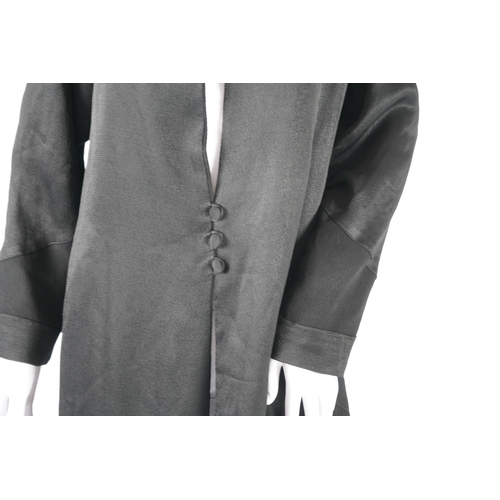 1512 - A 1930's black satin evening coat, with small collar and covered buttons to the front. Decorated wit... 