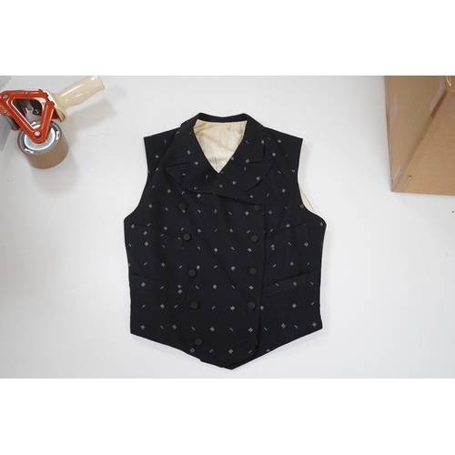 1514 - An Edwardian small gentlemans double breasted waistcoat, made from black woven wool, with a sprig d... 