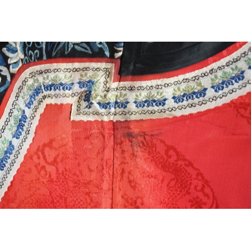 1528 - A late 19th century Chinese Manchu ladies red silk damask robe, with black and blue silk embroidered... 