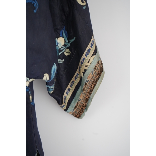 1531 - An early 20th century blue silk embroidered Chinese childs robe, embroidered with bats and flower m... 