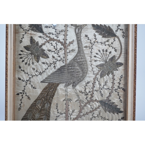 1535 - An Indian late 19th century silver metallic thread embroidery of a peacock in a flowering tree, embr... 