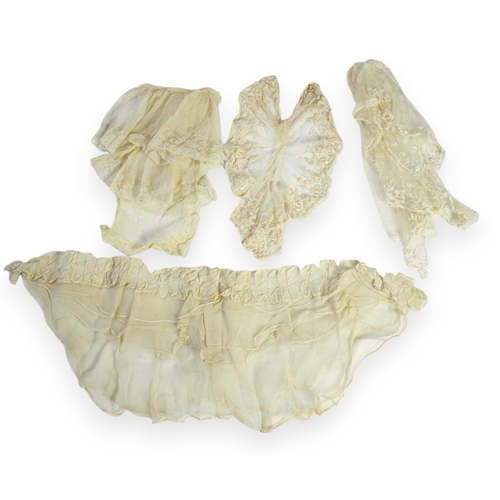 1536 - A suitcase containing a cream silk lace skirt to a dress, an Edwardian silk petticoat and various co... 