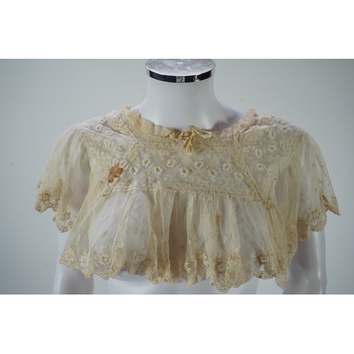 1536 - A suitcase containing a cream silk lace skirt to a dress, an Edwardian silk petticoat and various co... 