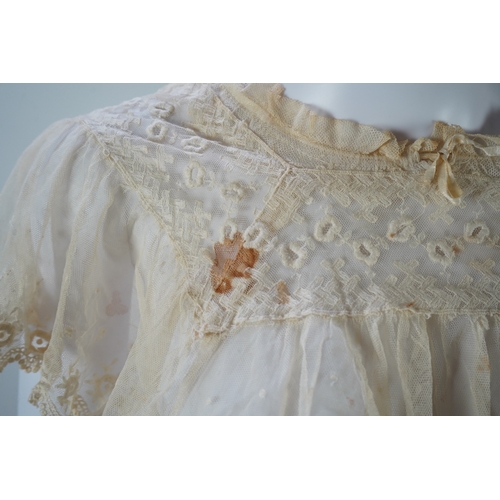 1536 - A suitcase containing a cream silk lace skirt to a dress, an Edwardian silk petticoat and various co... 