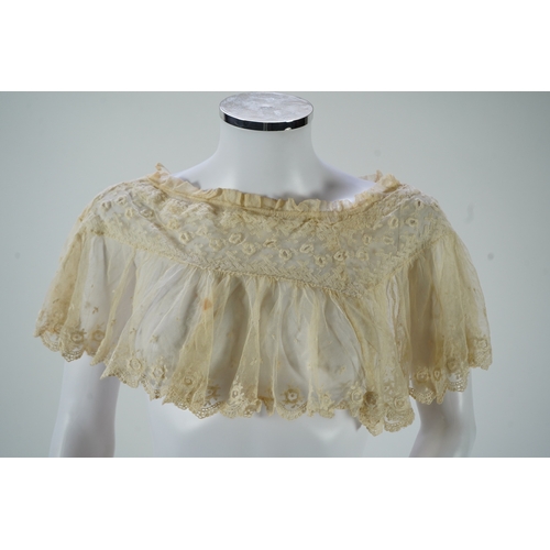 1536 - A suitcase containing a cream silk lace skirt to a dress, an Edwardian silk petticoat and various co... 