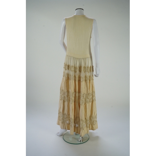 1536 - A suitcase containing a cream silk lace skirt to a dress, an Edwardian silk petticoat and various co... 