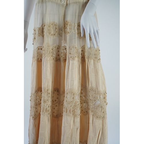 1536 - A suitcase containing a cream silk lace skirt to a dress, an Edwardian silk petticoat and various co... 