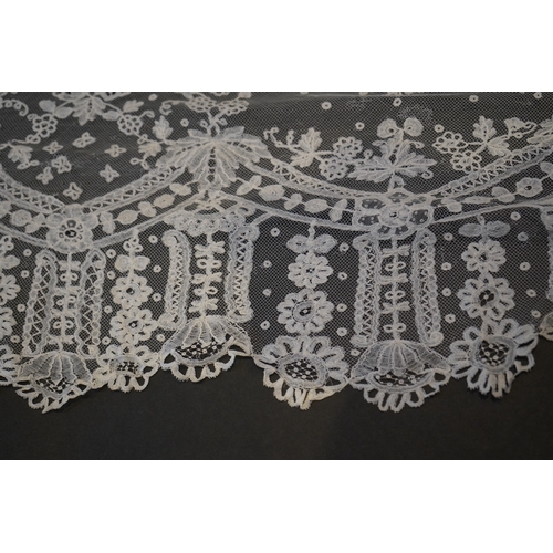 1546 - A deep elaborately designed flounce of mid 19th century Brussels bobbin appliquéd lace on net, with ... 