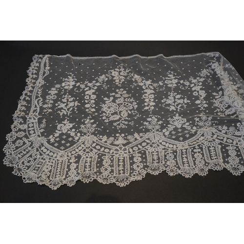 1546 - A deep elaborately designed flounce of mid 19th century Brussels bobbin appliquéd lace on net, with ... 