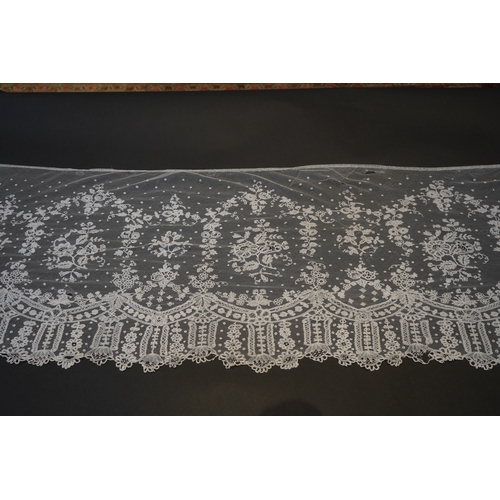 1546 - A deep elaborately designed flounce of mid 19th century Brussels bobbin appliquéd lace on net, with ... 