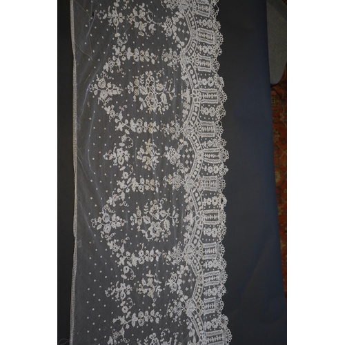 1546 - A deep elaborately designed flounce of mid 19th century Brussels bobbin appliquéd lace on net, with ... 