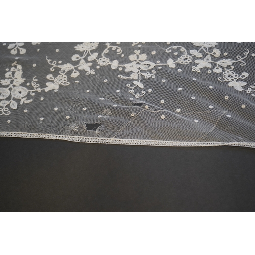 1546 - A deep elaborately designed flounce of mid 19th century Brussels bobbin appliquéd lace on net, with ... 