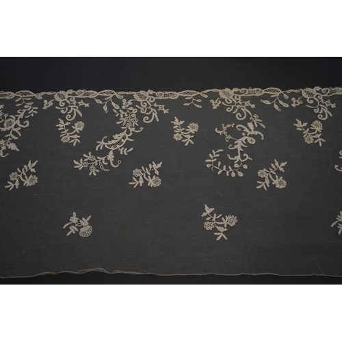 1547 - A 19th century five yard flounce of Brussels bobbin appliqué lace applied onto fine machine net, wor... 