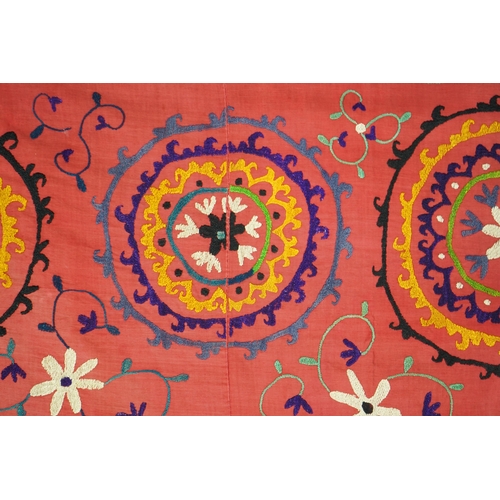 1557 - A large 20th century Uzbek multi coloured and embroidered Suzani wall hanging. The word Suzani meani... 