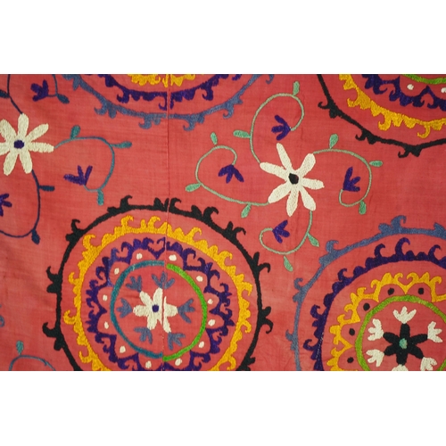 1557 - A large 20th century Uzbek multi coloured and embroidered Suzani wall hanging. The word Suzani meani... 