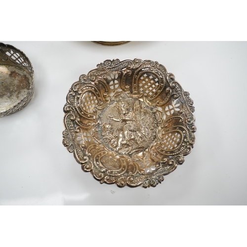 1871 - A pair of Edwardian pierced white metal dishes embossed with cherubs, a pair of two handled silver o... 