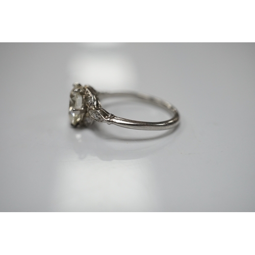 1908 - A platinum and single stone diamond set ring, with six stone diamond chip set foliate shoulders, the... 