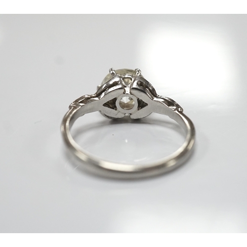 1908 - A platinum and single stone diamond set ring, with six stone diamond chip set foliate shoulders, the... 