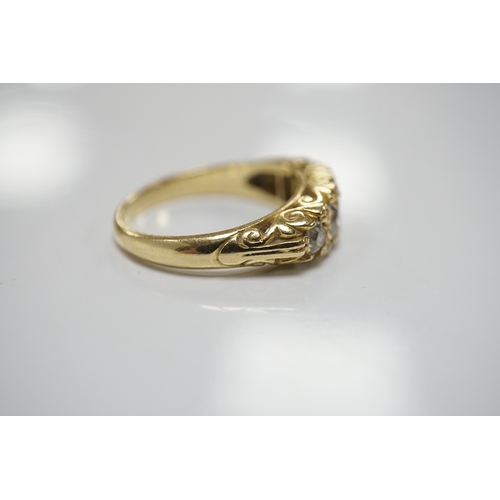 1910 - A modern Victorian style 18ct gold and graduated five stone diamond set half hoop ring, with rose se... 