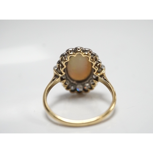 1911 - A mid 20th century 18ct, white opal, square and round cut diamond set oval cluster ring, size O, gro... 