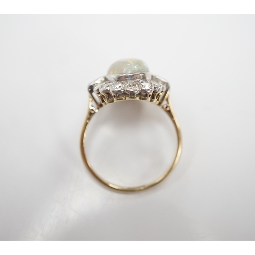 1911 - A mid 20th century 18ct, white opal, square and round cut diamond set oval cluster ring, size O, gro... 