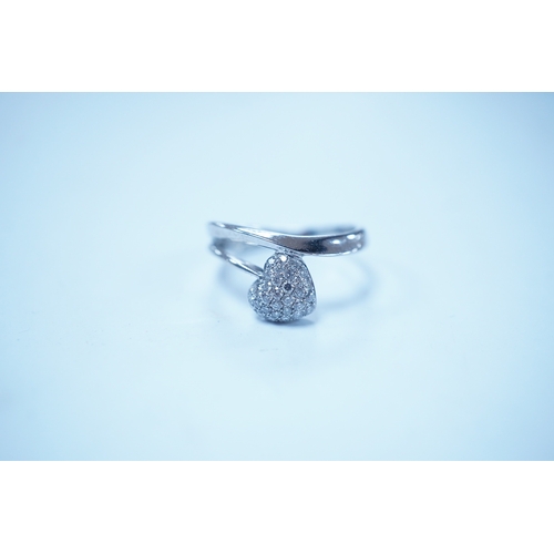 1929 - A modern 18k white metal and pave diamond set heart shaped ring, size H, gross weight 2.1 grams. Con... 