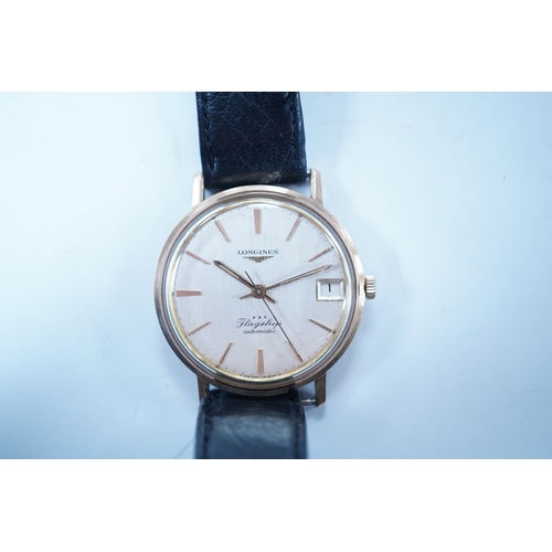 1937 - A gentleman's 9ct gold Longines Flagship automatic wrist watch, with baton numerals and date apertur... 