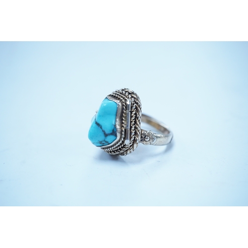 1948 - A Chinese gilt white metal and turquoise set 'poison ring' the hinged compartment opening to reveal ... 