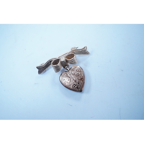 1955 - A modern engraved 9ct gold heart shaped locket, on an associated 9ct gold ribbon bow suspension broo... 