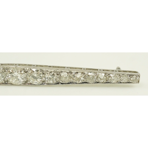 1967 - A 1920's platinum? and nineteen millegrain set graduated diamond bar brooch, 59mm, gross weight 4.6 ... 