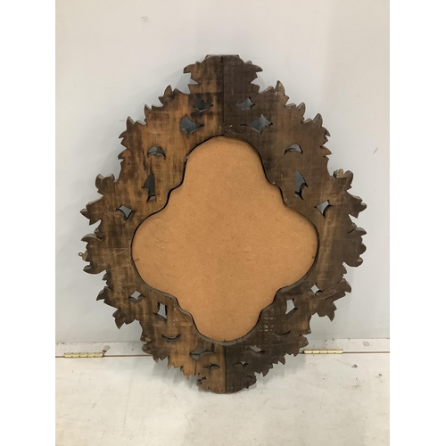 13 - An 18th century style shaped oval carved pine wall mirror, width 61cm, height 79cm. Condition - fair... 