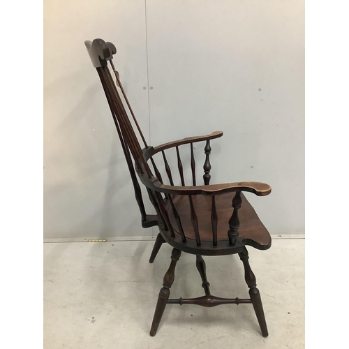 20 - A 20th century American Windsor beech comb back armchair, width 73cm, depth 51cm, height  113cm. Con... 