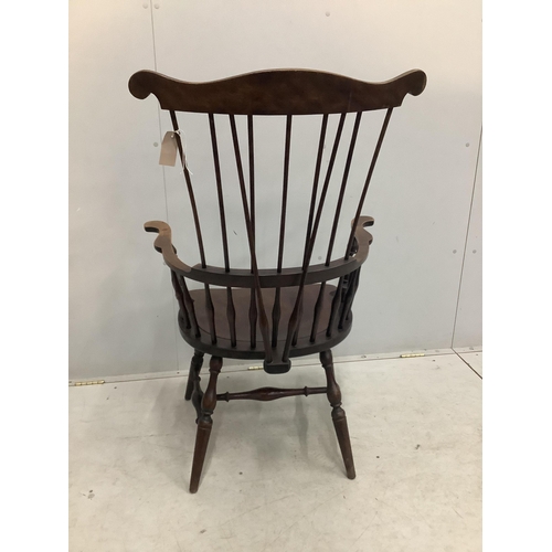 20 - A 20th century American Windsor beech comb back armchair, width 73cm, depth 51cm, height  113cm. Con... 