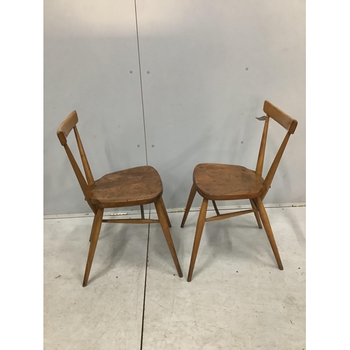 21 - A pair of mid century Ercol elm and beech stacking chairs, width 39cm, depth 35cm, height 76cm. Cond... 