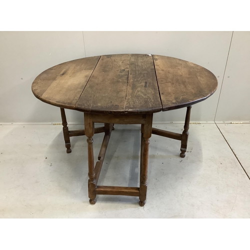 24 - A small late 17th century oak oval topped gate leg table, width 100cm, depth 45cm, height 70cm. Cond... 