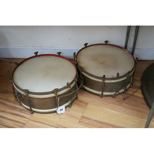 252 - A pair of A H Matthews military brass side drums, both stamped London 1949, 35.5cm diameter skin. Co... 