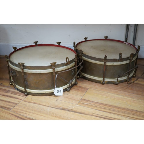 252 - A pair of A H Matthews military brass side drums, both stamped London 1949, 35.5cm diameter skin. Co... 