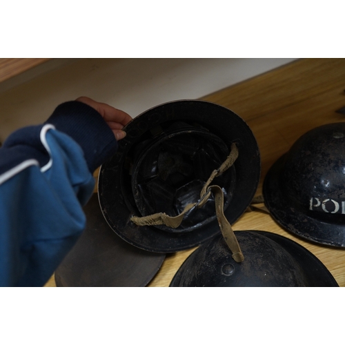 257 - Seven early to mid 20th century military tin helmets; including one stencilled with POLICE. Conditio... 