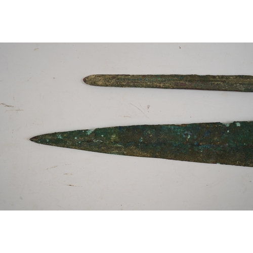 264 - Two assorted Bronze Age spearheads, one of leaf shape with turned over tang, the other short with na... 